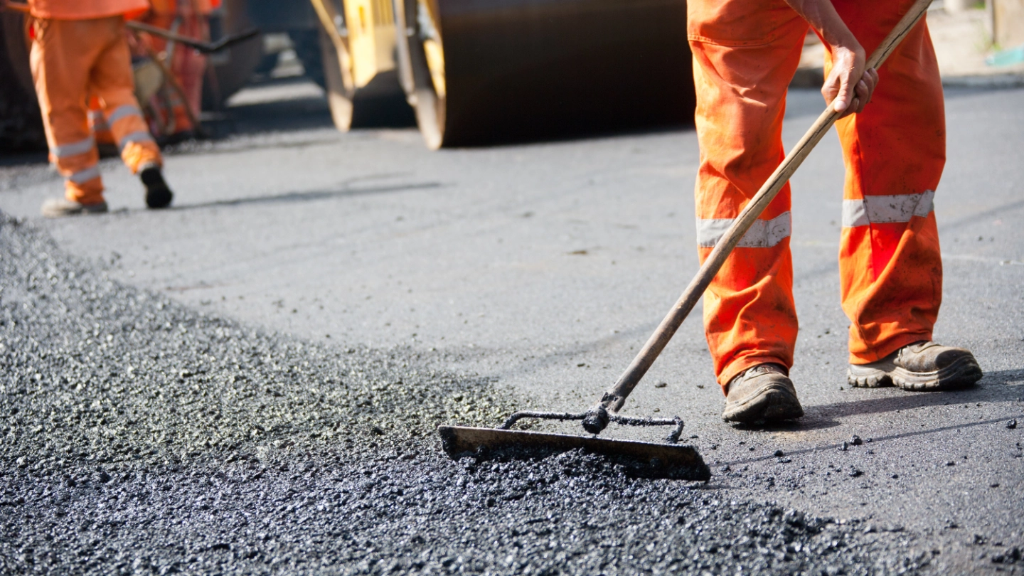 Construction workers laying tarmacadam roads construction workers laying tarmacadam roads