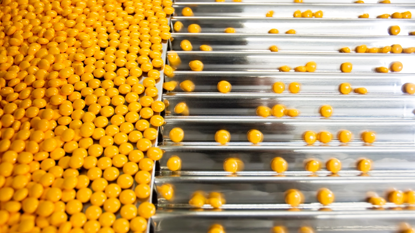 pills on a conveyor belt image