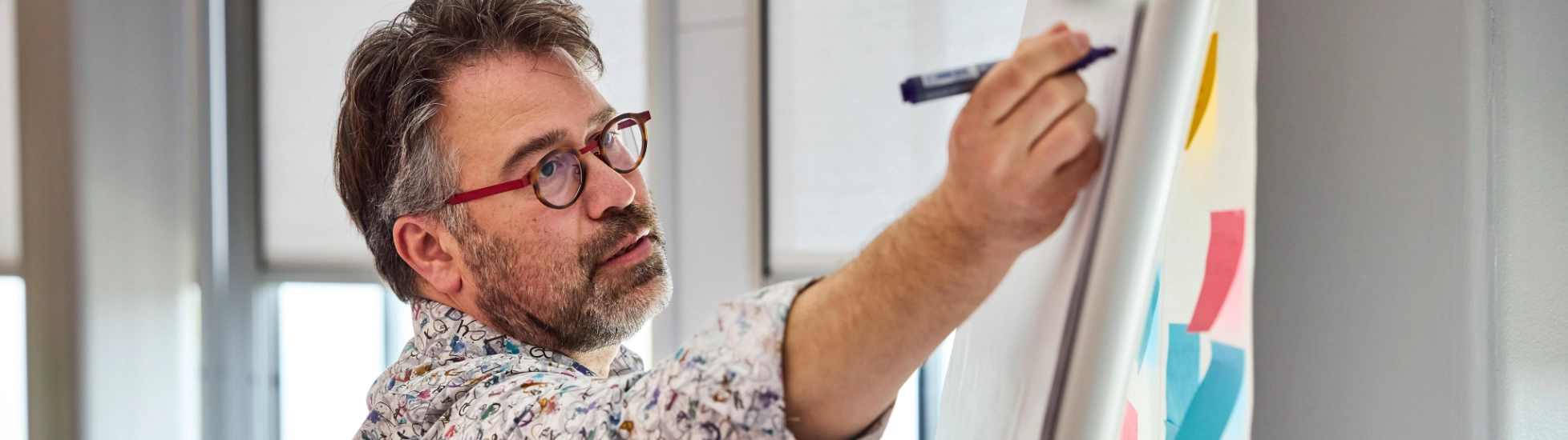 Atradius Man making notes on a flipchart at a workshop