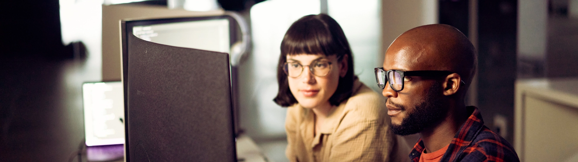 Male and female compute analysts working in front of computer