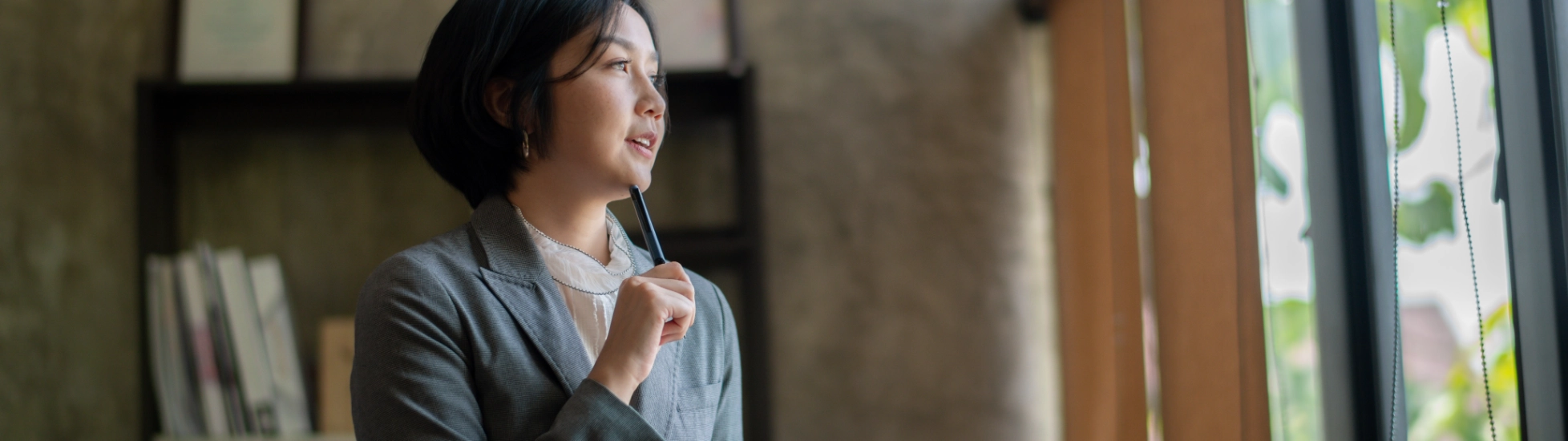 woman holding notebook and thinking