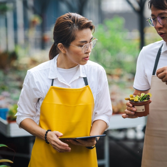 Asian agricultural workers discussing growing techniques