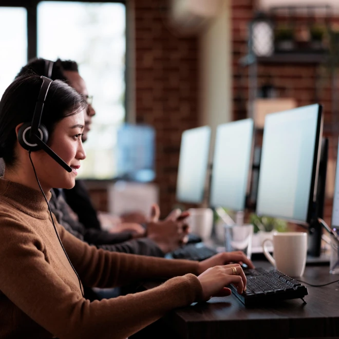 Woman at helpdesk working on computer